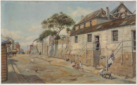 A dirt road lined with houses and children playing.