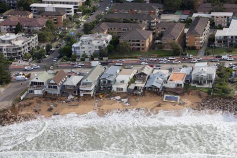 aerial image of beach front houses after a storm has washed the backyards away