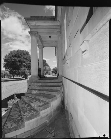 A curved staircase leading to a small balcony